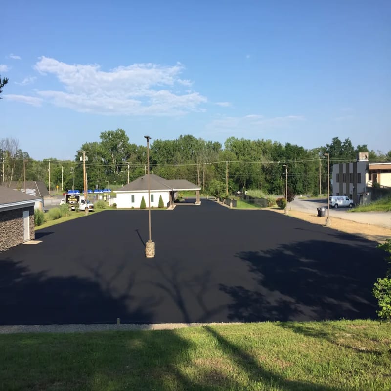 Freshly sealcoated driveway with proper matte finish in Albany NY